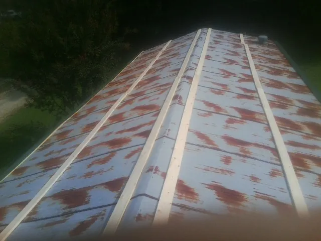 Rusted metal roof panels with new wood purlins before replacement — Storm Damage Roof Repair in Rowlett by Roofing Brothers
